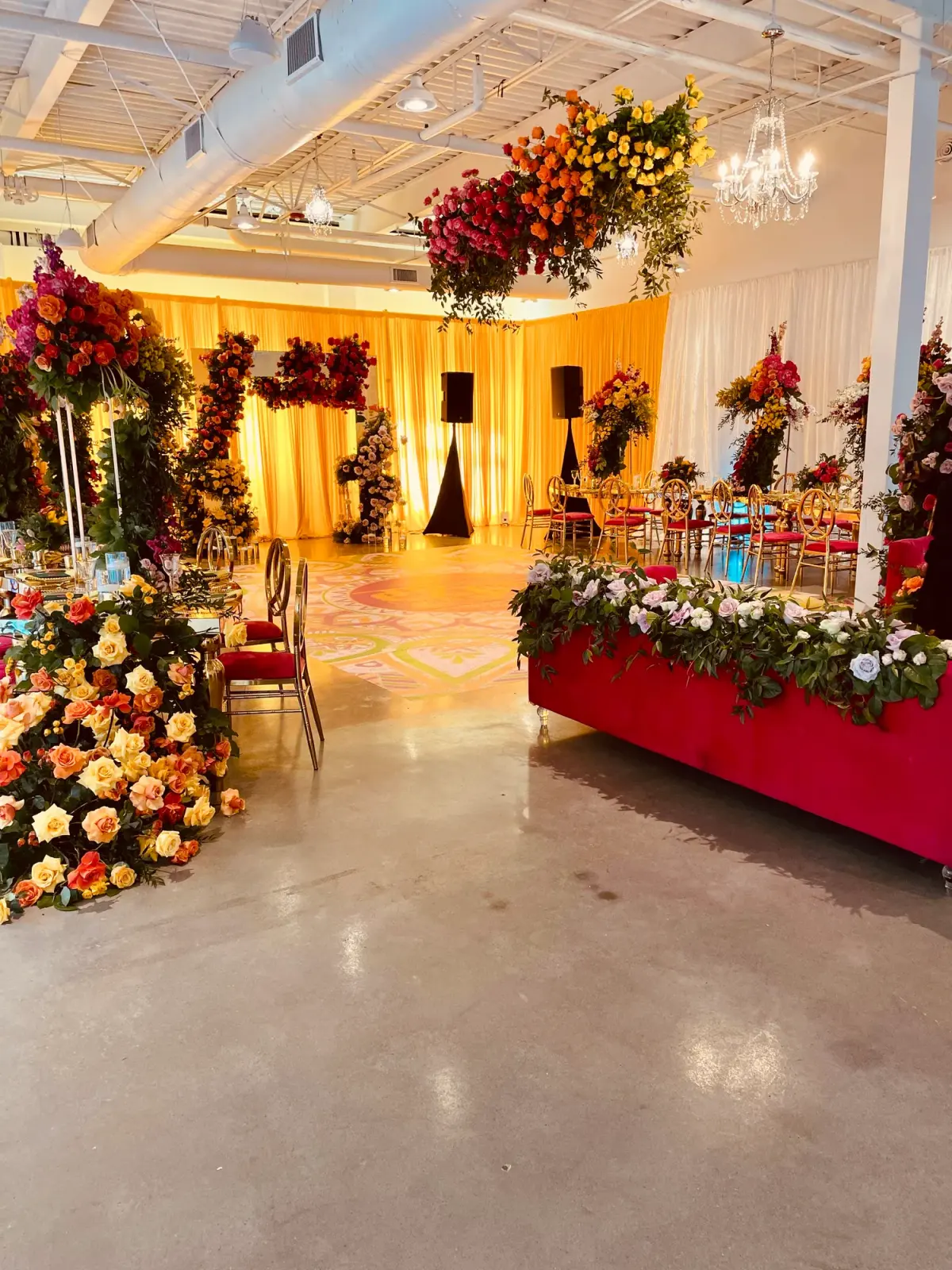 Red and gold entrance floral design by Greystone