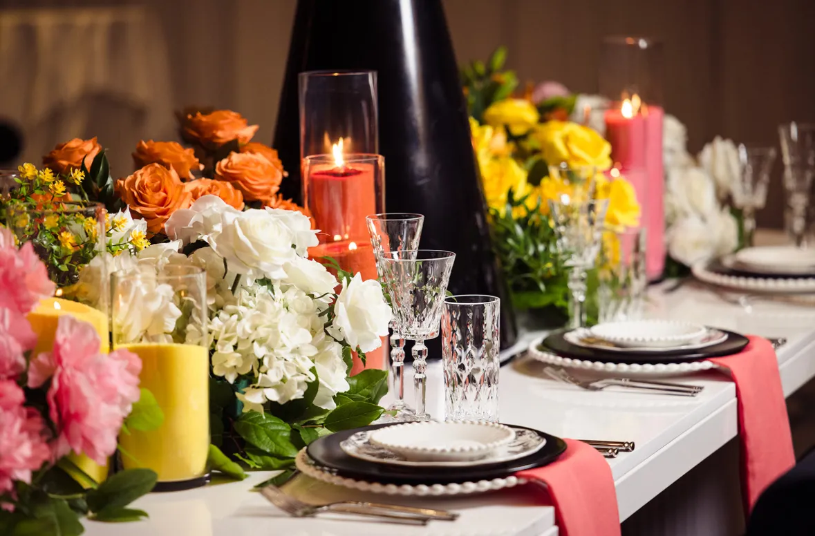 Orange and white tablescape with candles by Greystone
