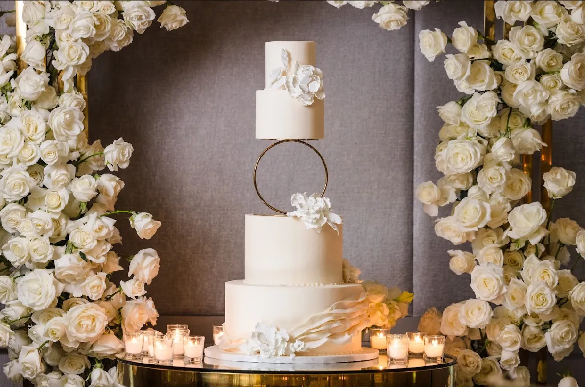 Wedding cake with floral topper designed by Greystone